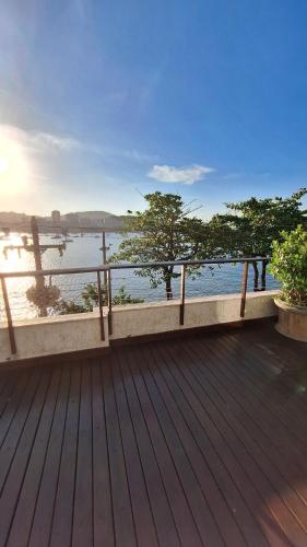 a wooden deck with a view of the water at Luna Rossa Guest House in Rio de Janeiro