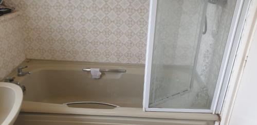 a bathroom with a shower and a tub and a sink at Private and Quiet Room in Harlow near Stansted Airport in Harlow