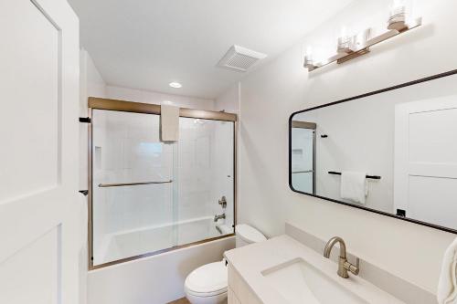 a white bathroom with a sink and a mirror at Yampa Valley Escape in Steamboat Springs