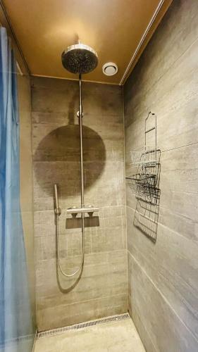 a shower stall in a bathroom with a shower at ApartmentInCopenhagen Apartment 1634 in Copenhagen