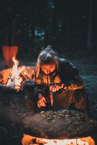 a man sitting in front of a fire at Villa Fregn in Ljørdal