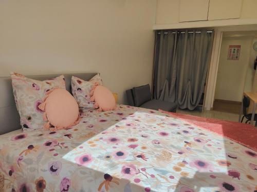 une chambre avec un lit avec des oreillers roses dans l'établissement Bel appartement avec piscine, à Martigues