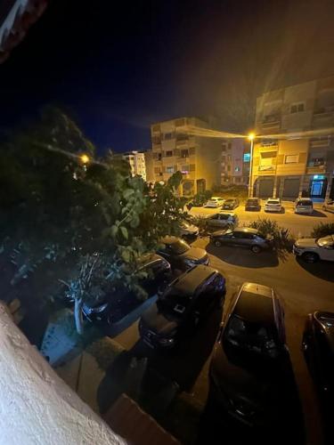 a parking lot with cars parked in the snow at Appartement dunes de Martil in Martil