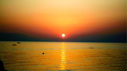 a sunset over the ocean with the sun setting at Siviri Sunset Amazing Sea View- With fireplace -Starlink wifi in Siviri