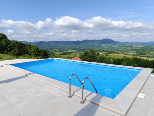 a swimming pool with a view of the mountains at Villa Vista in Banja Luka