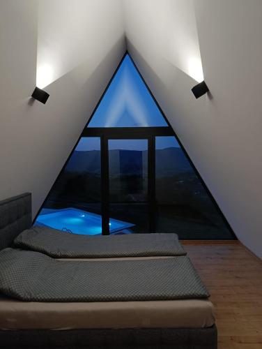 a room with two beds in a room with a window at Villa Vista in Banja Luka
