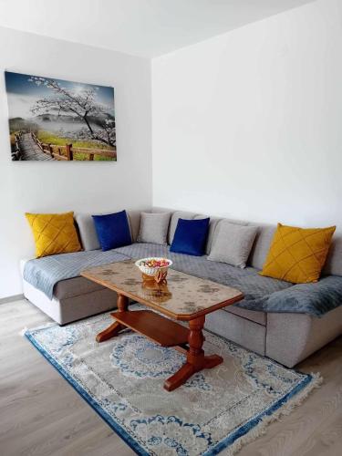 a living room with a couch and a coffee table at Panorama Plužine Apartment in Pluzine