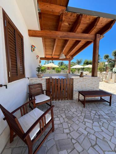 a patio with two chairs and a table at Villa Paternelli in Bisceglie