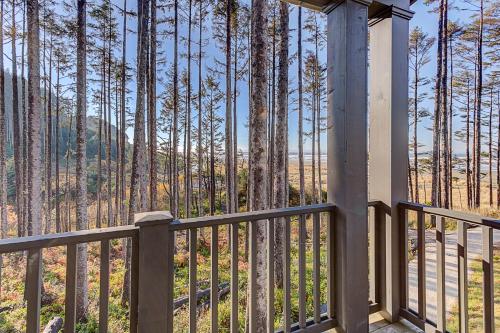 a porch with a view of a forest of trees at Seaforever by Seabrook Hospitality in Pacific Beach