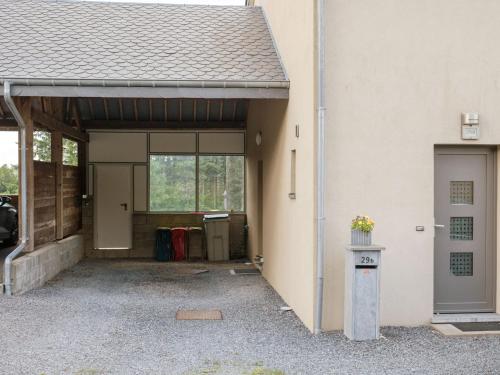 an entrance to a garage with a building at Appartement Sur Jardin Verdoyant in Bertrix