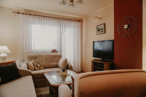 a living room with a couch and a tv at 3-Bedroom Residence - Prime Location with City View and Parking in Sarajevo