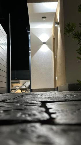 an open door with a light in a room at Poolhouse Flip Flop - mit privatem Pool in Vir