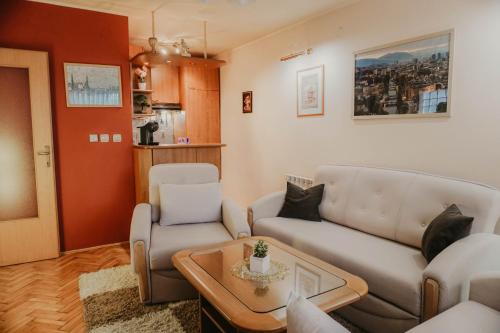 a living room with a couch and a table at 3-Bedroom Residence - Prime Location with City View and Parking in Sarajevo