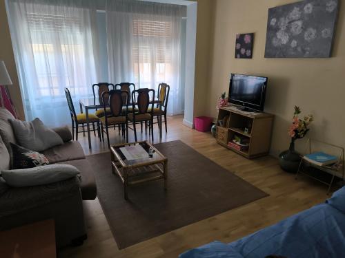a living room with a couch and a table and chairs at La Puebla in Ponferrada