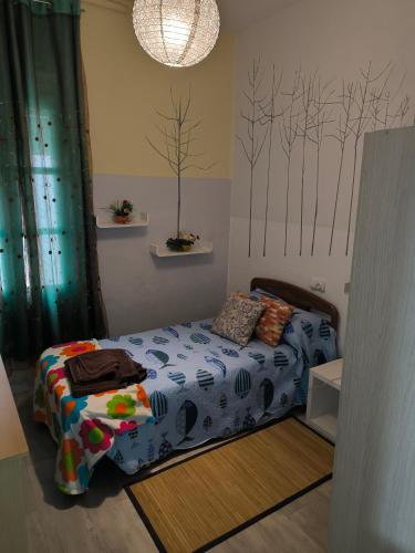 a bedroom with a bed and trees on the wall at La Puebla in Ponferrada