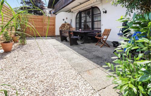 a backyard with a ping pong table and chairs at Ferienhaus - Mondsee in Mondsee