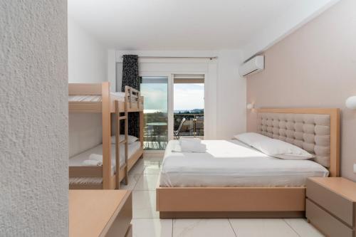 a bedroom with two bunk beds and a balcony at Art Studios in Neos Marmaras