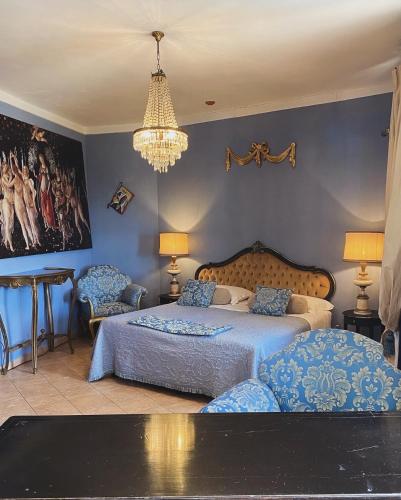 a bedroom with two beds and a chandelier at Sotto il cielo di Toscana appartamenti in tenuta only adults no pet in Camaiore