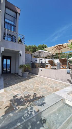 a house with a patio with a view of the ocean at Sarti Thea in Sarti