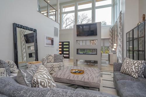 a living room with a couch and a tv at Skyview Oasis Modern Build 1 Mile from Downtown Black Mtn! in Black Mountain