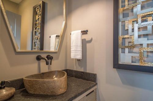 a bathroom with a sink and a mirror at Skyview Oasis Modern Build 1 Mile from Downtown Black Mtn! in Black Mountain