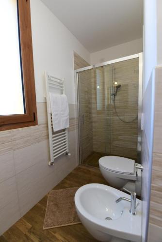 a bathroom with a sink and a toilet and a shower at La Cerqua in Arcevia