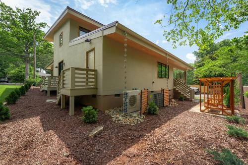 a small house with a porch and a yard at Skyview Oasis Modern Build 1 Mile from Downtown Black Mtn! in Black Mountain