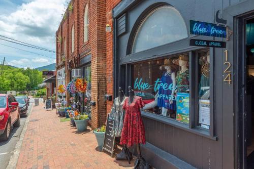 a store with a window on the side of a street at Skyview Oasis Modern Build 1 Mile from Downtown Black Mtn! in Black Mountain