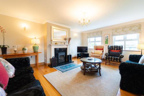 a living room with a couch and a fireplace at House 23 Ard na Mara in Dingle