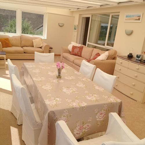 a living room with a table and chairs at Curlews Cottage - House with 3 bedrooms and garden - walking distance to the beach in Perranporth