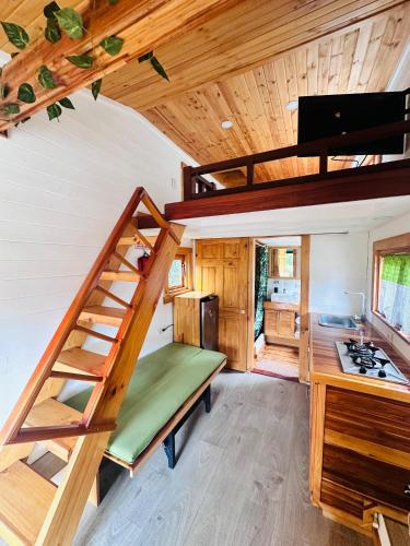a tiny house with a staircase in a kitchen at Riverside La Masía Ecohotel in Quindío