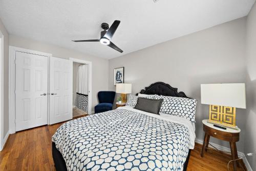 a bedroom with a bed and a ceiling fan at The Carriage House Retreat in Houston