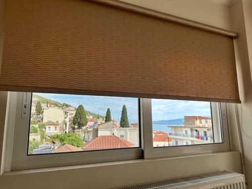 a window with a window shade in a room at Angel Luxury Aptm Amfilochia in Amfilochía