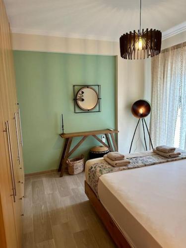 a bedroom with a bed and a lamp and a window at Angel Luxury Aptm Amfilochia in Amfilochía