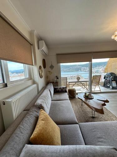 a living room with a large couch and a large window at Angel Luxury Aptm Amfilochia in Amfilochía
