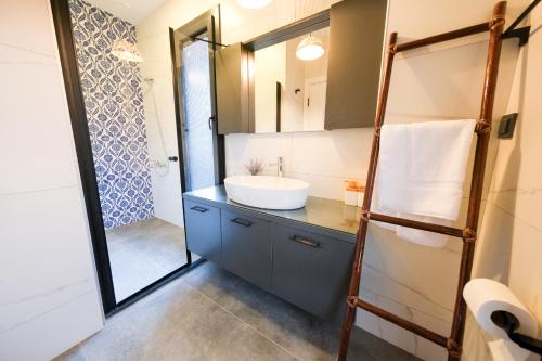 a bathroom with a sink and a mirror at Lily of the Valley Luxury Villa Fethiye, Yesiluzumlu by Sunworld Villas in Fethiye