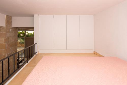 a room with white walls and a large window at Rikanthos Stone Sea View Apartment ΙΙ in Kissamos