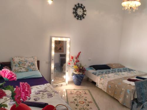 a bedroom with two beds and a mirror in it at Studio in Dahab