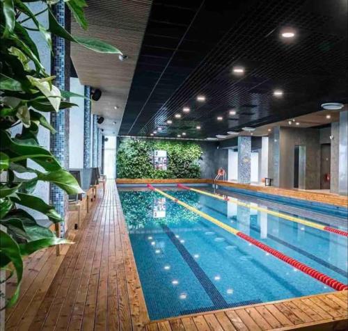 a large swimming pool in a large building at Apartment by seaside in Ķesterciems