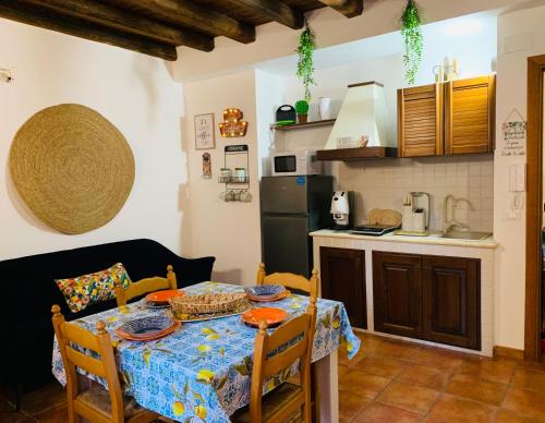a kitchen with a table with a blue table cloth at Cathedral House in Palermo