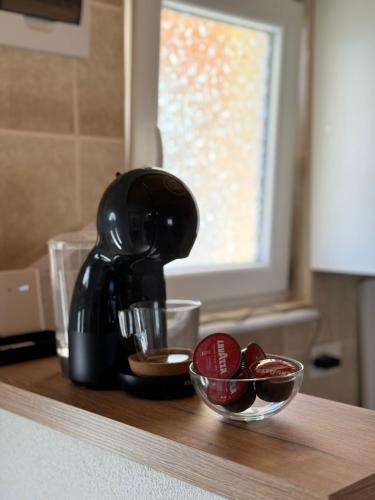a coffee maker on a counter with a bowl of fruit at Mountain Houses Šarović in Žabljak