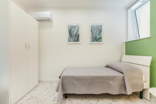 Postel nebo postele na pokoji v ubytování Ciraccio Apartments