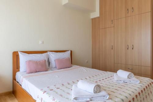 a bedroom with a bed with pink and white towels at Litochoro Olympus Studio in Litochoro