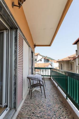 a balcony with a bench on the side of a building at Litochoro Olympus Studio in Litochoro