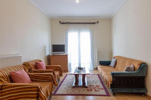 a living room with two couches and a coffee table at Litochoro Olympus Studio in Litochoro