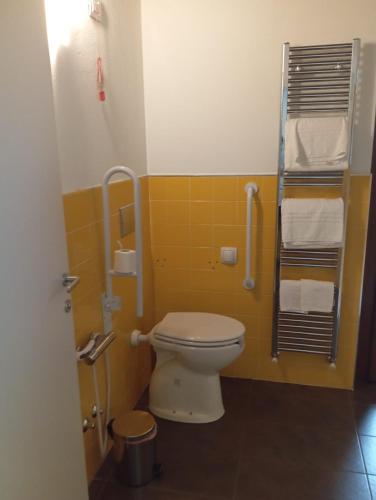 a bathroom with a toilet and a shower with towels at Bes Residence Bergamo Polaresco in Bergamo