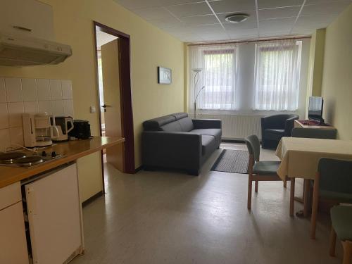 a living room with a couch and a kitchen at Hotel Zum Bären in Kurort Altenberg