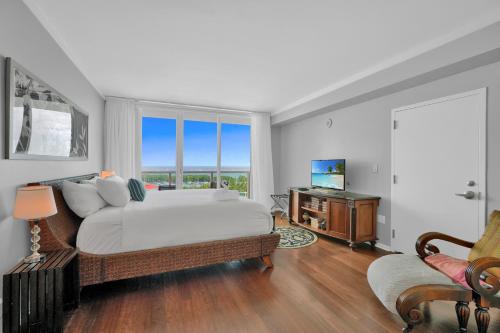 a bedroom with a large bed and a television at Astonishing SEA VIEW Studio in Grove in Miami