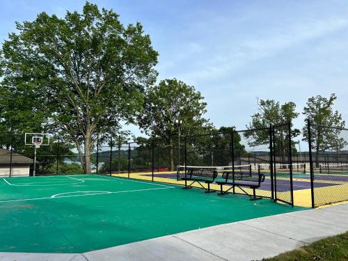a tennis court with a net and a basketball hoop at Serenity Oaks at The Getaways in Kimberling City