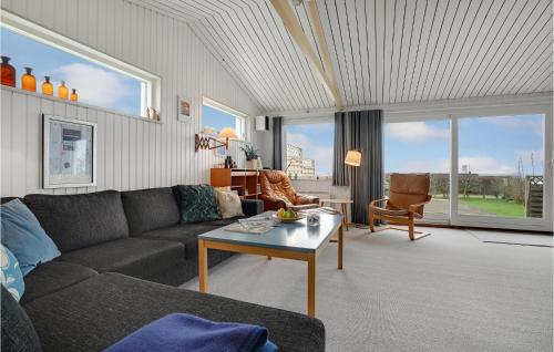 a living room with a couch and a table at Cozy Home In Assens With House Sea View in Assens